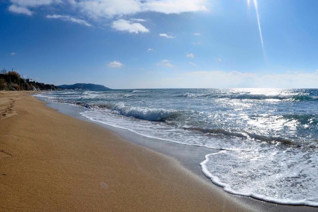 Waves on the long sandy beach of Agios Georgios, Southern Corfu
