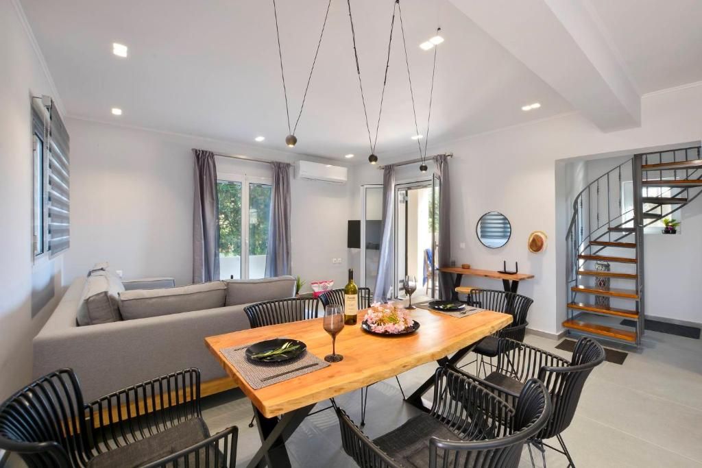 Wooden dining table with the spiral staircase to the upper floor