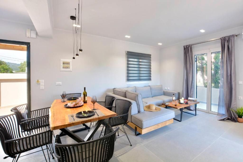 Dining table and sofa in the bright open-plan living area